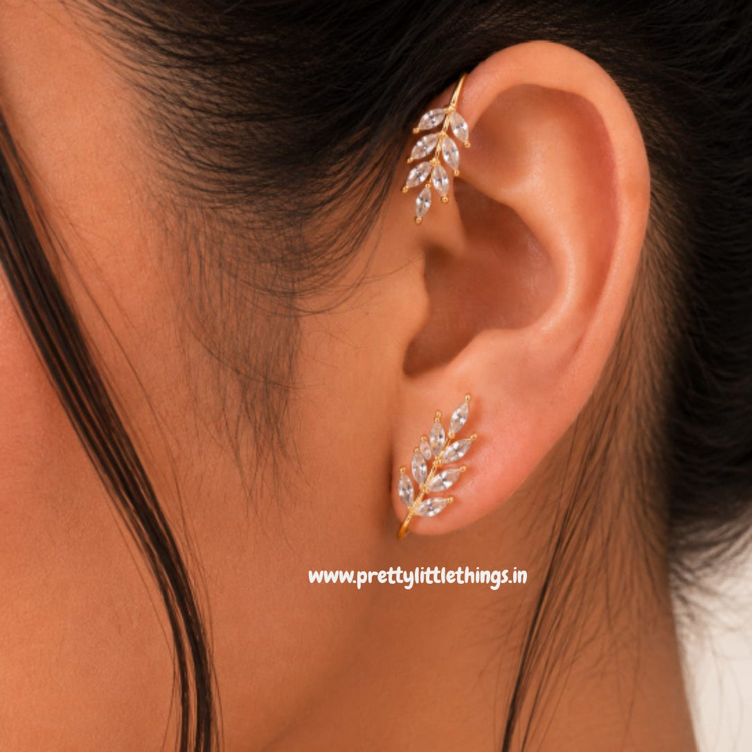 Close-up of an ear wearing decorative ear wrap style earring with a blurred background.