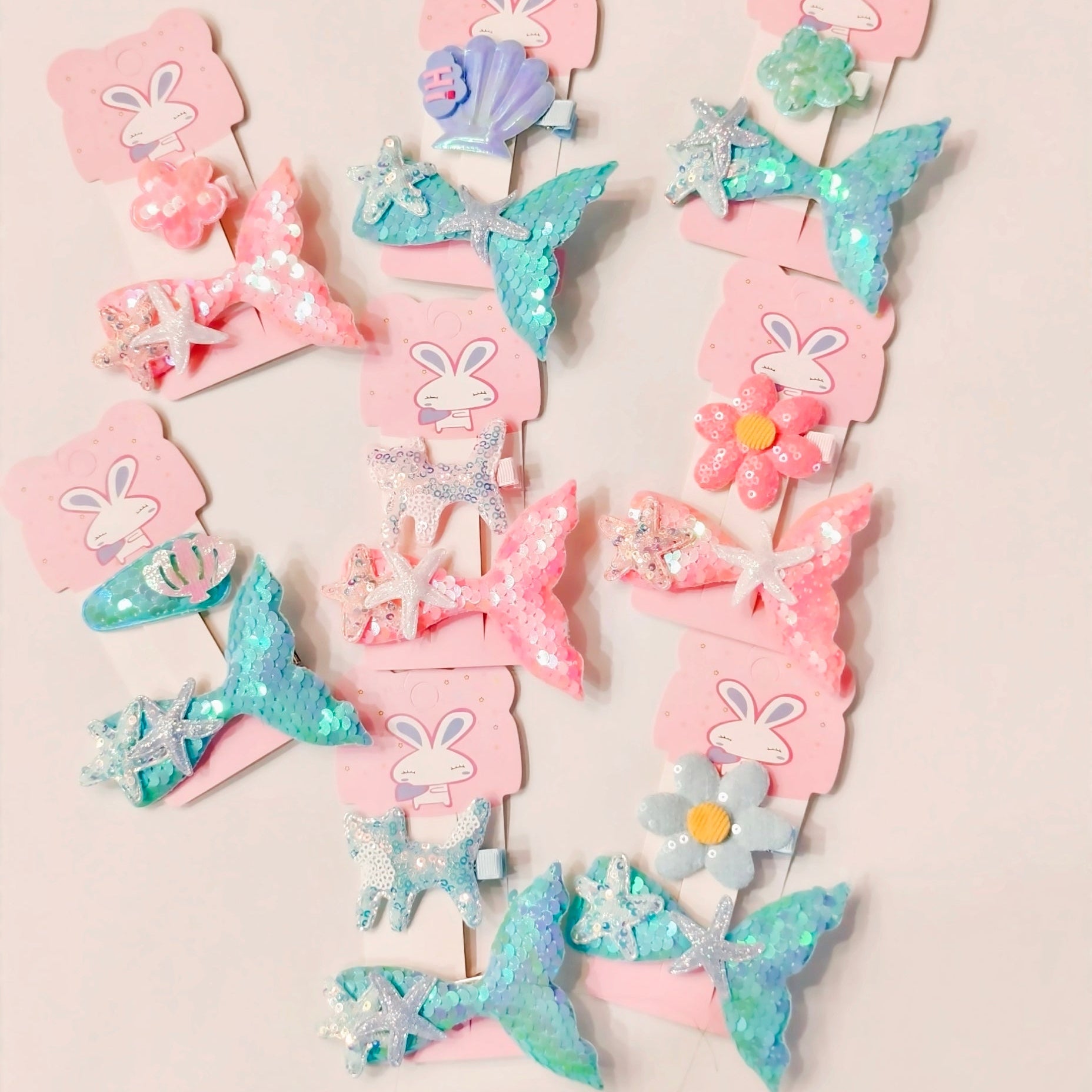 sequins shimmer mermaid and flowers design hair clips set. hair clips are in pink and turqouise colors. 