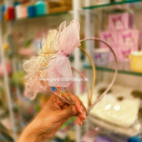 slim hard hairbands with light colored bows design. bows have shimmer stripes on them. 