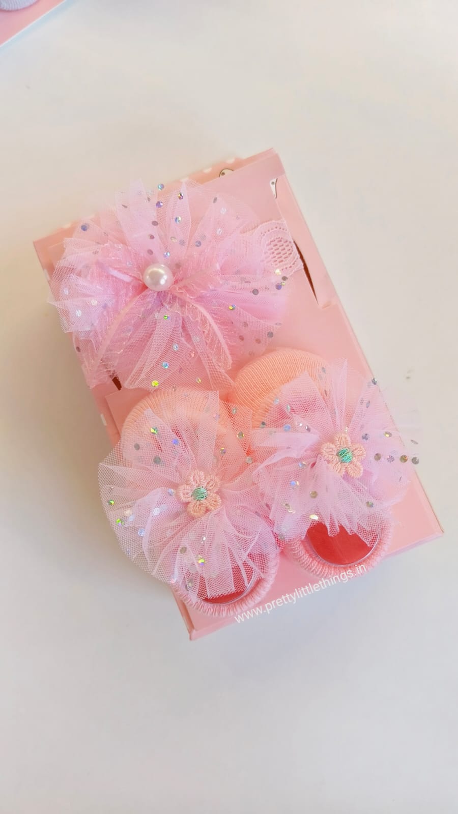 Decorative pink hair accessories with flowers on a white background
