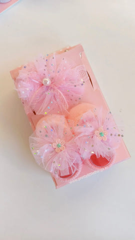 Decorative pink hair accessories with flowers on a white background