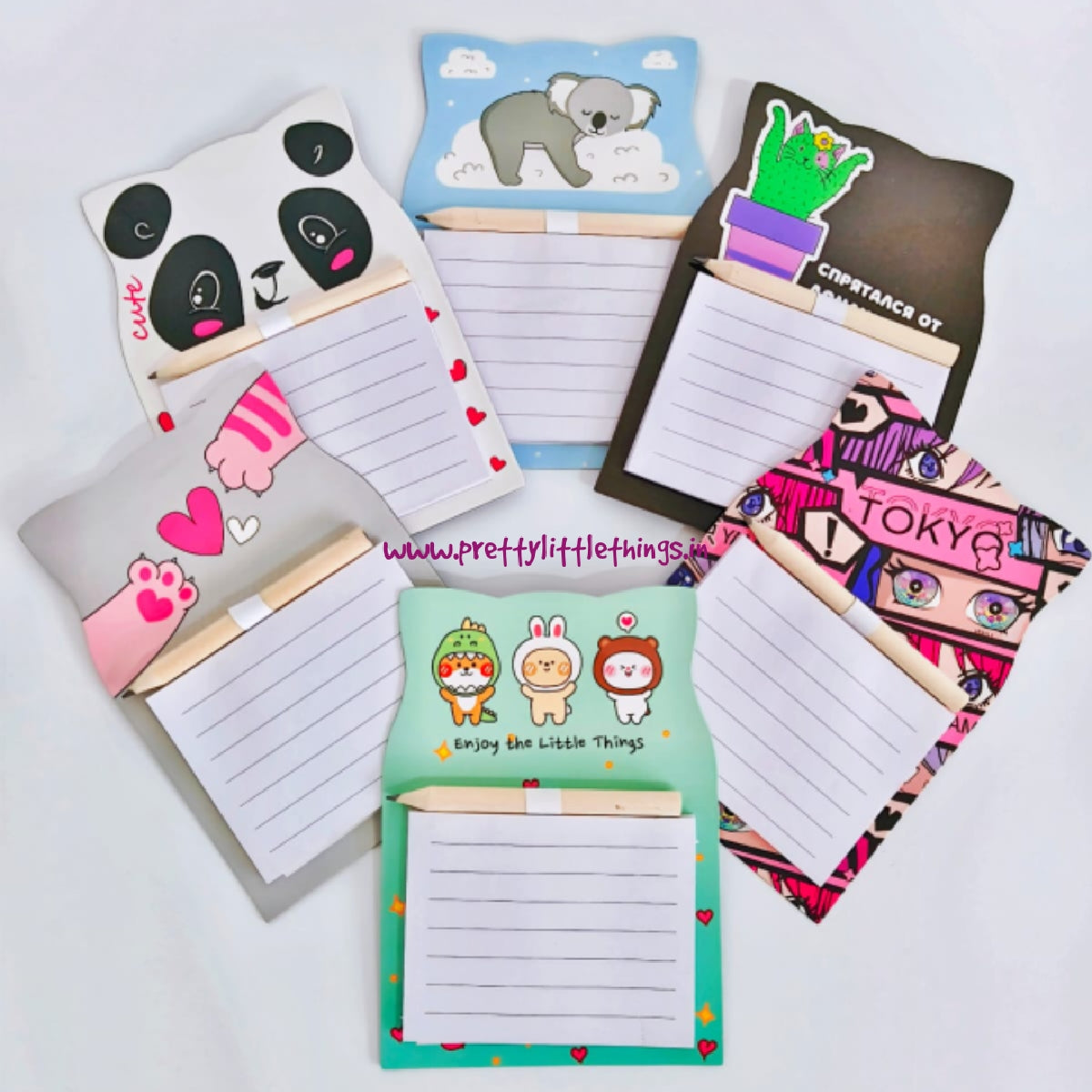 Set of colorful magnetic notepads with various designs on a white background