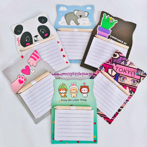 Set of colorful magnetic notepads with various designs on a white background