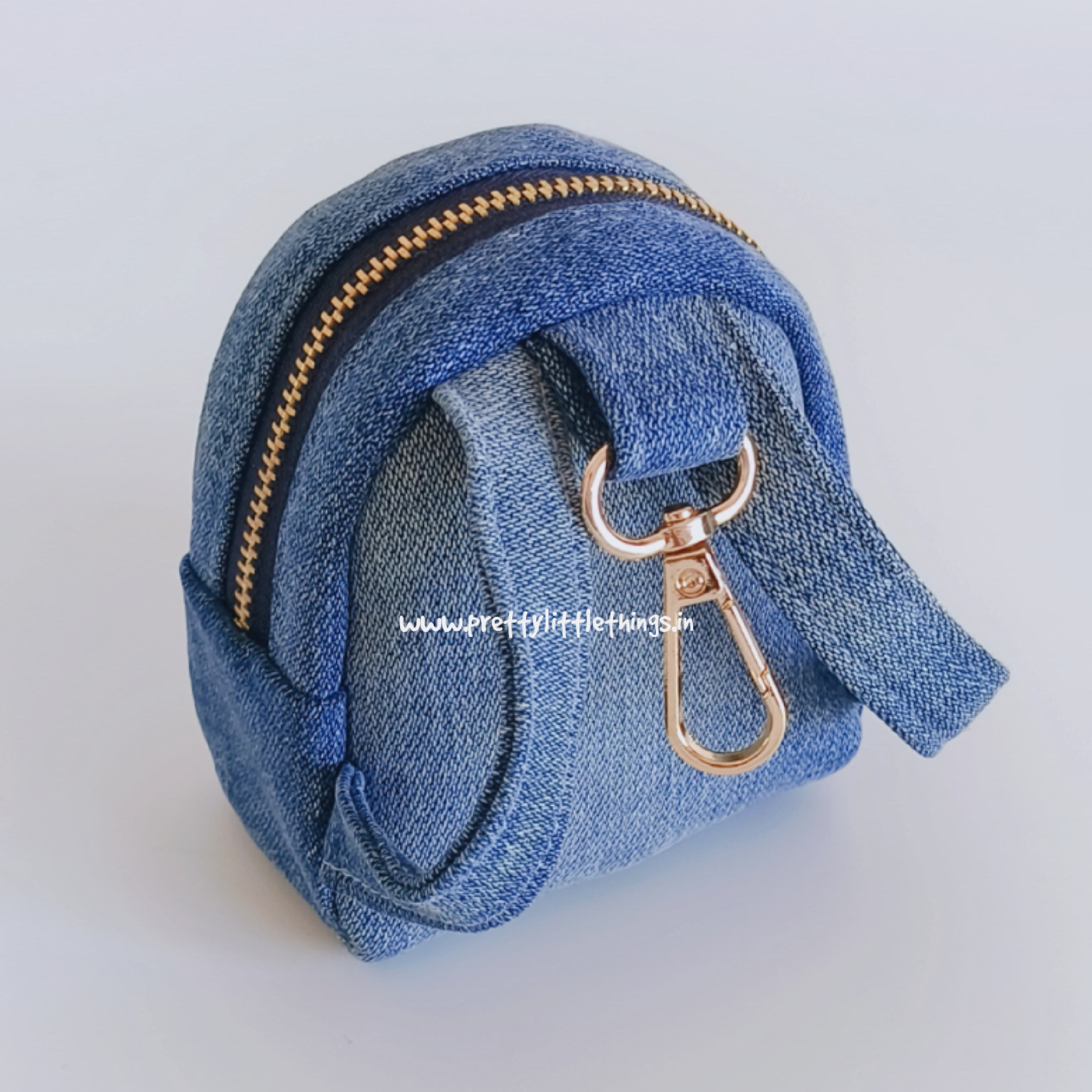Blue denim coin purse with gold zipper and clasp on a white background