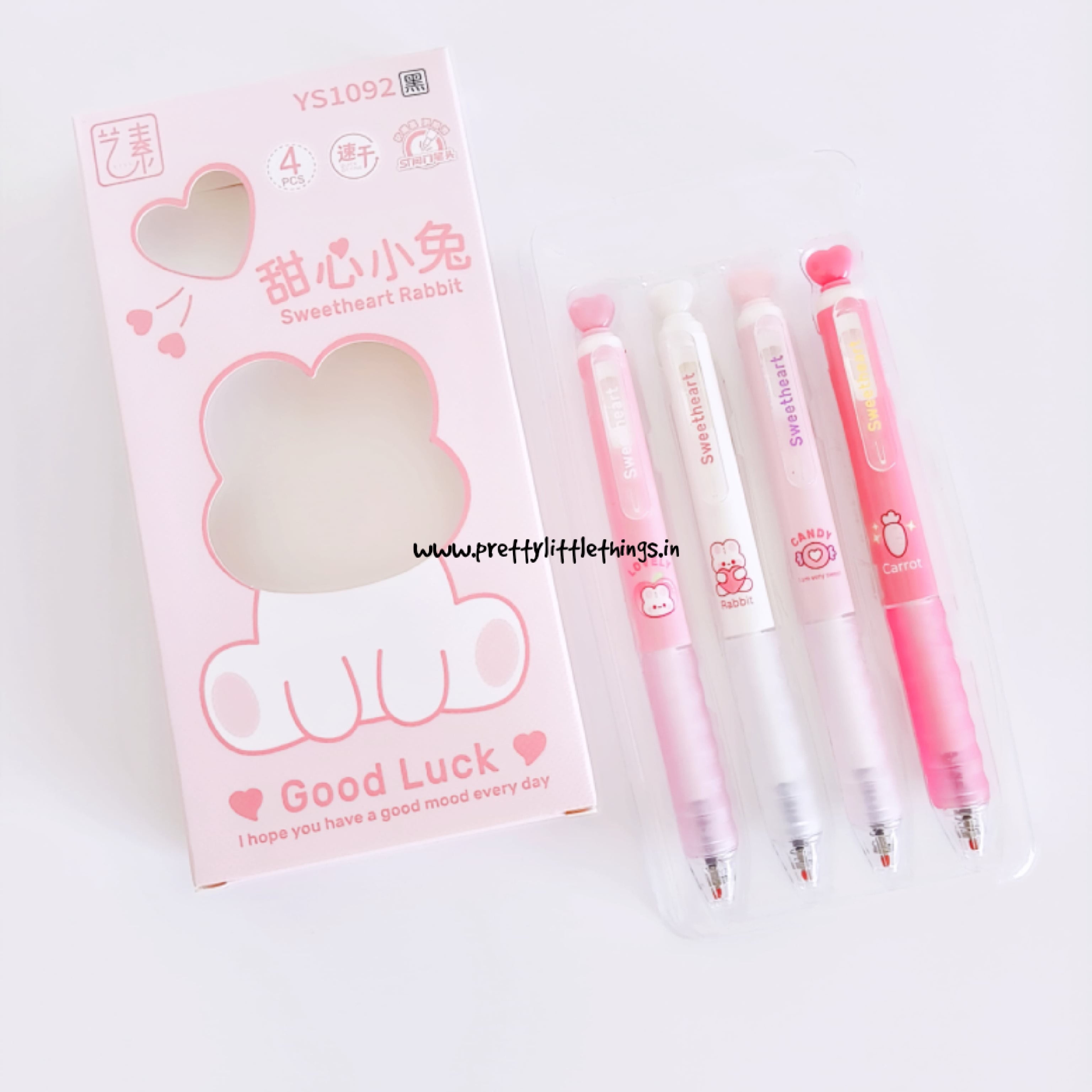 Set of pink kawaii cartoon-themed pens with cute packaging on a white background