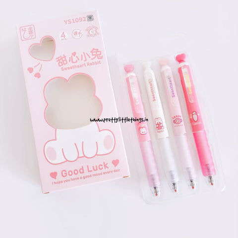 Set of pink kawaii cartoon-themed pens with cute packaging on a white background