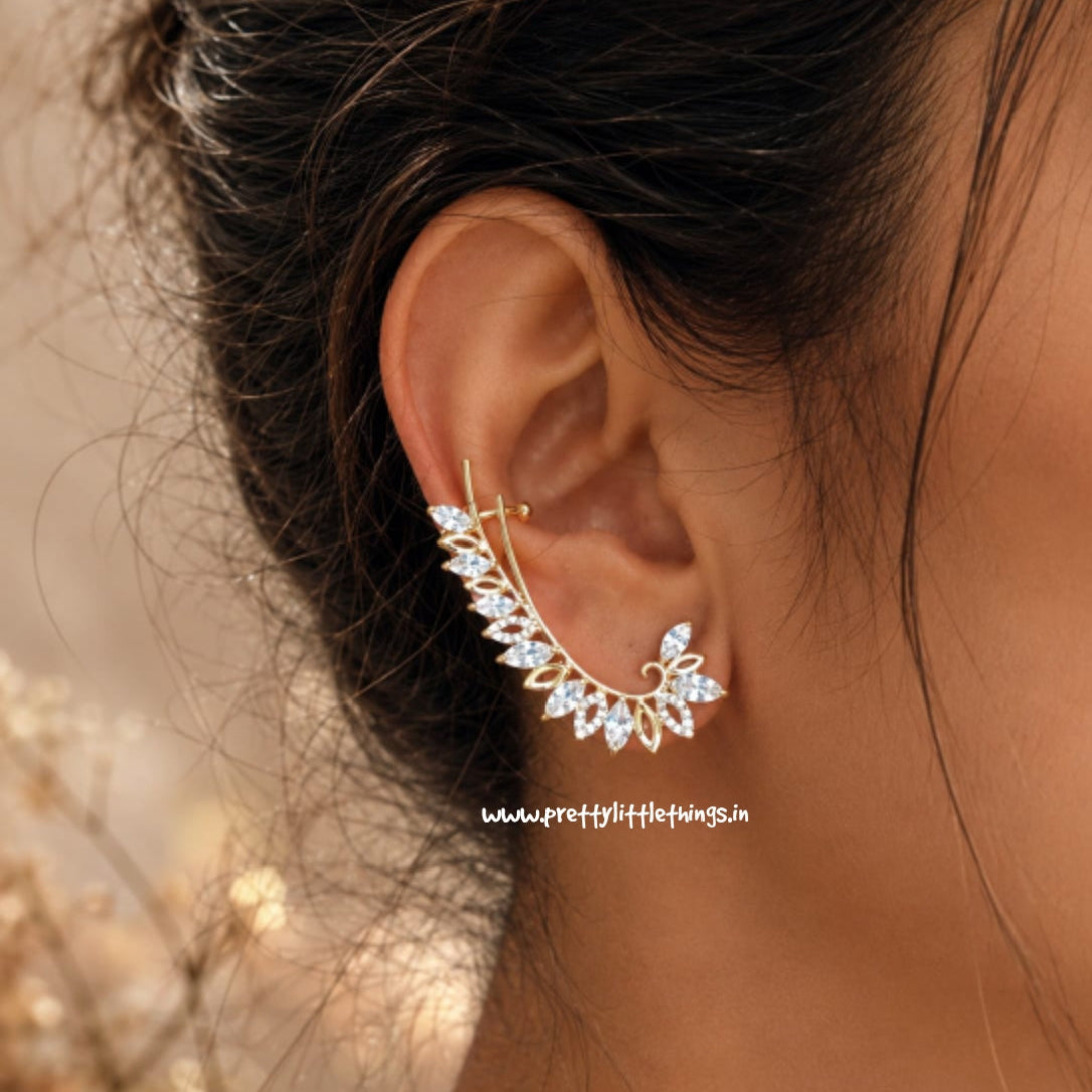 Close-up of an ear with a decorative ear cuff, blurred natural background