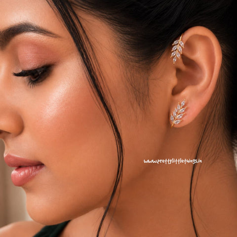 Close-up of a woman wearing a leaf-shaped ear wrap earring with a blurred background