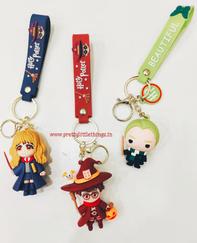 Three Harry Potter-themed keychains with colorful straps on a white background.