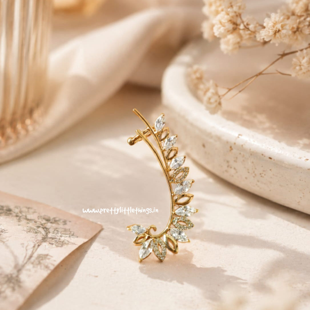 Golden tarnish resistant earcuff studded with AD on a soft beige background